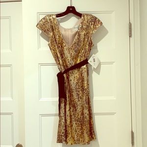 Gold sequined dress, with ribbon black belt.